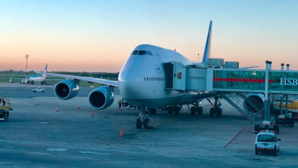 white and black airplane on airport during daytime